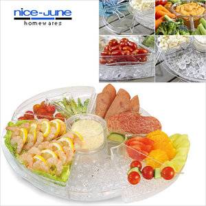 Appetizers on ice/large revlving server holds venied food trays over a bed of ice