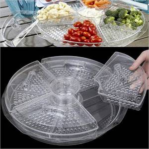 Appetizers on ice/large revlving server holds venied food trays over a bed of ice
